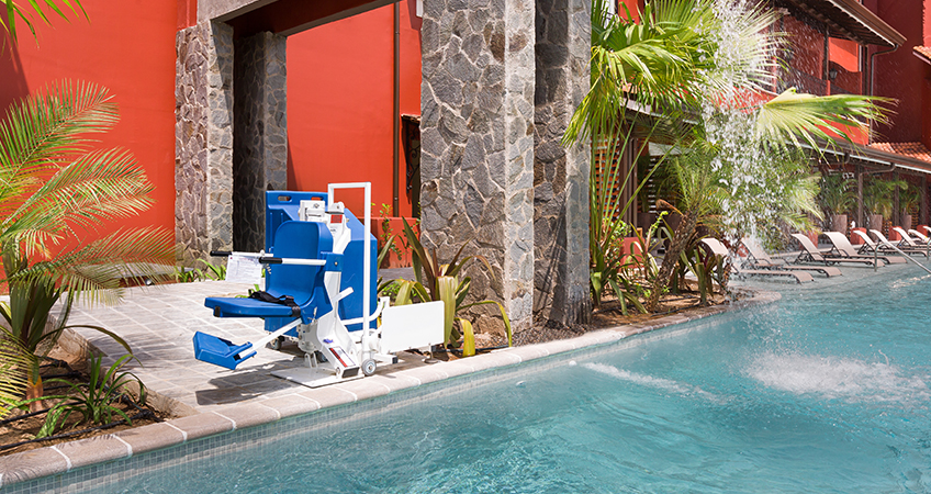 disabled-friendly swimming pool surrounded by vegetation which gives more privacy