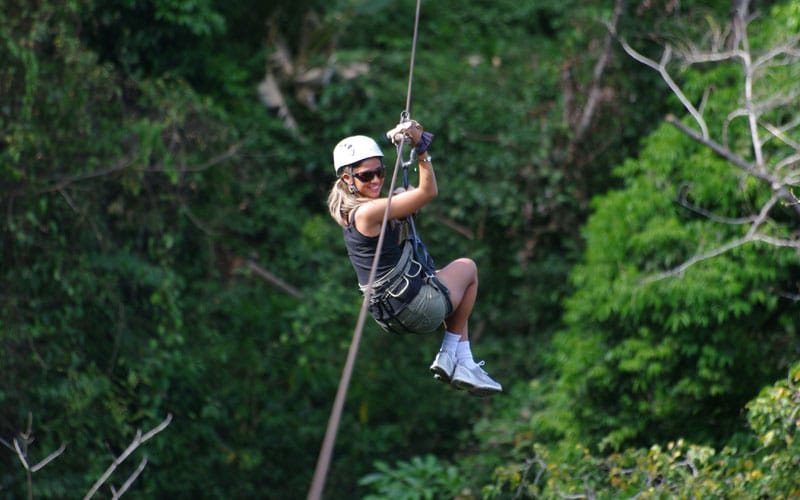 Person doing canopy tour in Costa Rica's rainforest