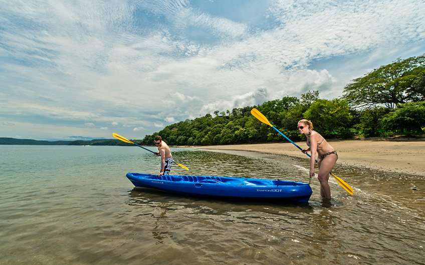 A couple is ready to have some fun while sea kayaking, which is one of the preferred things to do in Guanacaste.