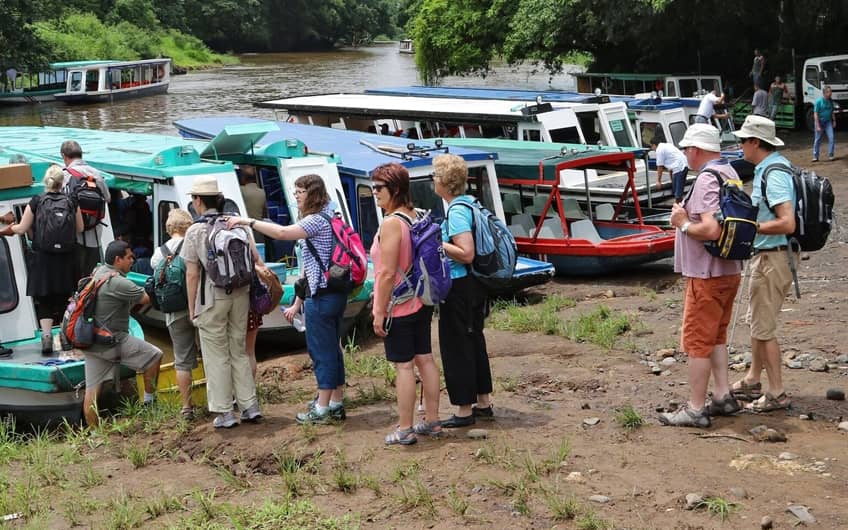 Group boarding boat to Tortuguero National Park